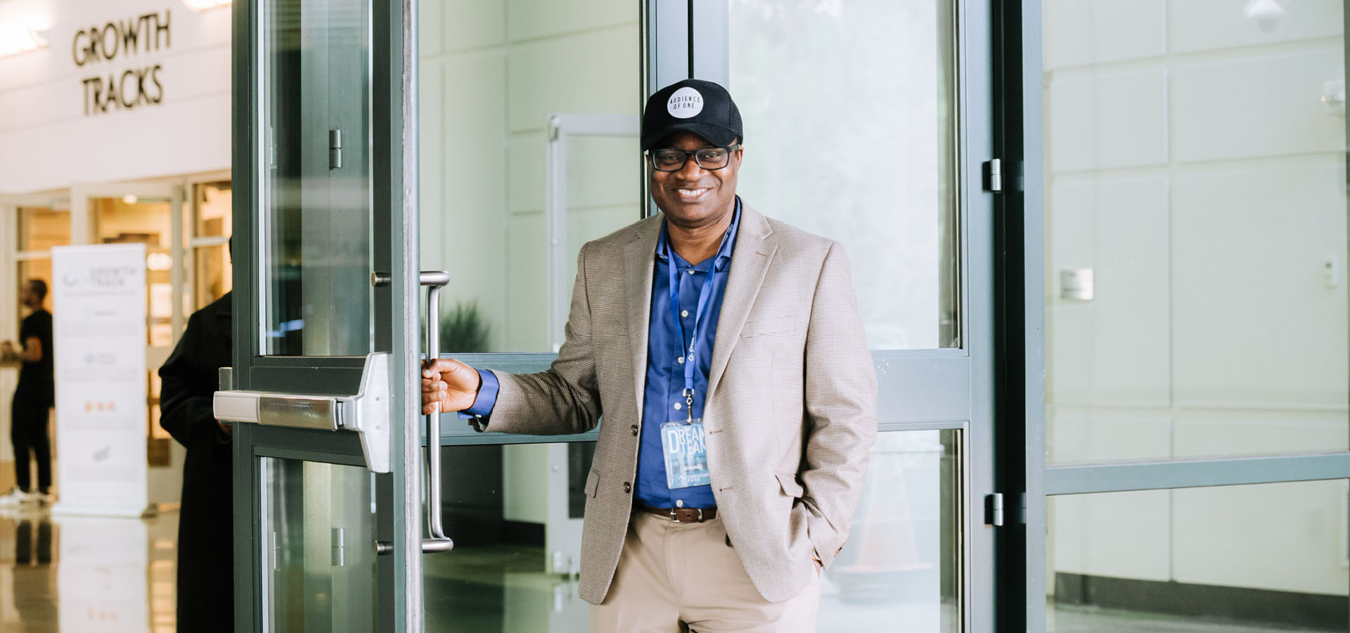 Dream Team member opening the door and greeting people