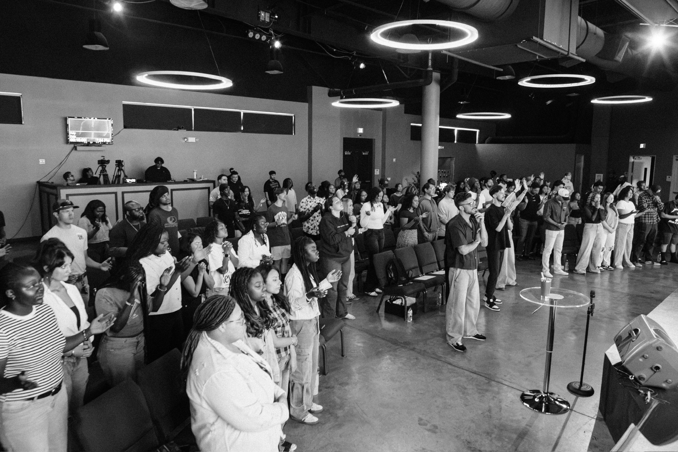 Young adults worshipping with hands raised